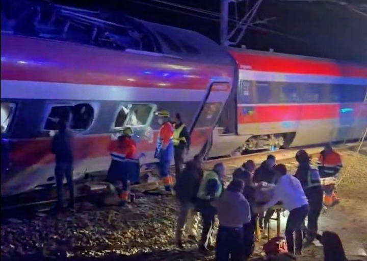 Emergency responders work at the site after a passenger train derailment disrupted rail services in Spain today.